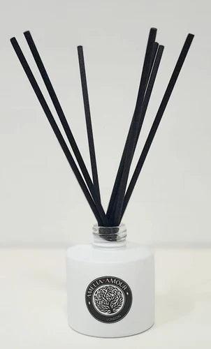 White Ceramic diffuser bottle with 8 reed sticks. Amelia Amour